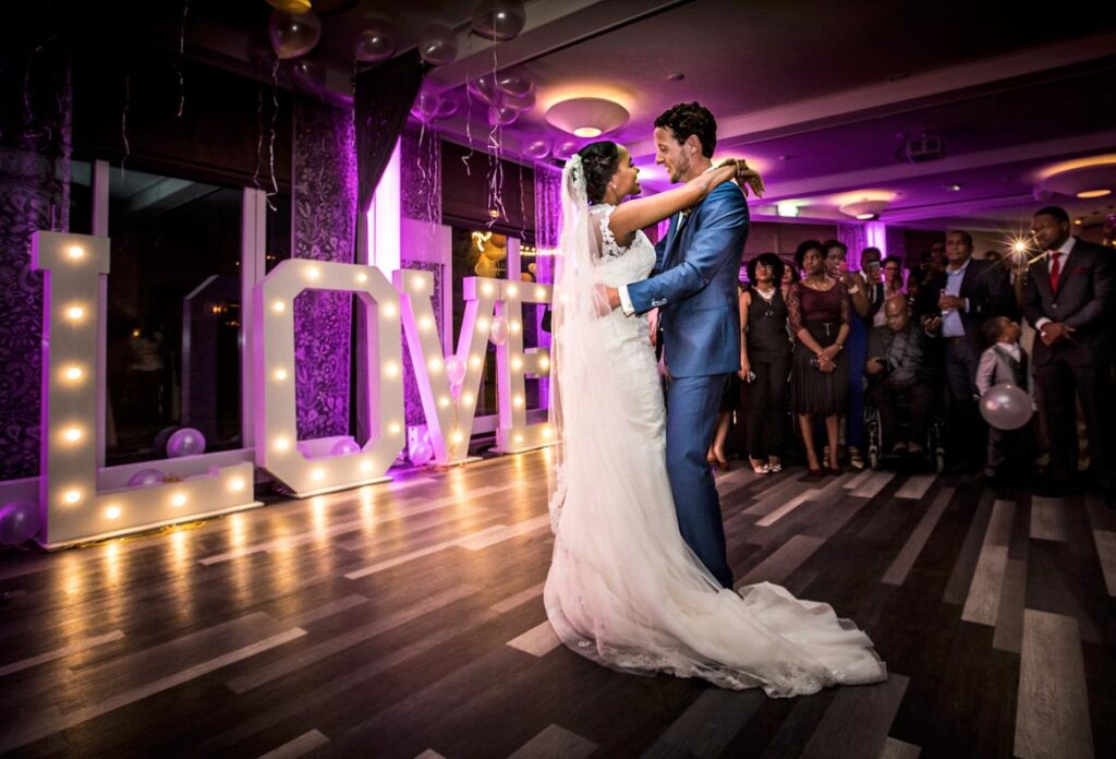 Trouwfotograaf Helmond Brandevoort Eindhoven Geldrop Mierlo Asten of Someren // Trouwdag in Beeld Bruidsfotograaf // Zijn jullie op zoek naar een trouwfotograaf? Het moment waarop al maanden is geoefend; de openingsdans met de mooie Love letters en vrienden en familie dichtbij, net voordat het feest losbarst bij Auberge du Bonheur Tilburg. Trouwfotograaf Trouwdag in Beeld voor een trouwreportage zoals jullie dag écht was. Échte emoties. Pure liefde. Tijdloze trouwfotografie.